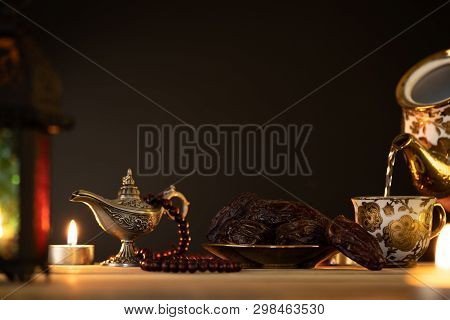 Ramadan Food And Drinks Concept. Ramadan Lantern With Arabian Lamp, Wood Rosary, Tea, Dates Fruit An