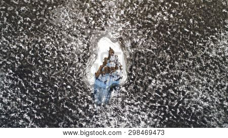 Aerial View From Drone Of A Small Island In Melting Ice Lake