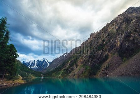 Wonderful Mountain Lake With View On Giant Glacier. Amazing Huge Mountains With Conifer Forest. Larc