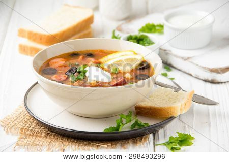 Traditional Russian Soup Solyanka With Beef, Chicken, Sausage, Lemon, Olives And Pickled Cucumber. D