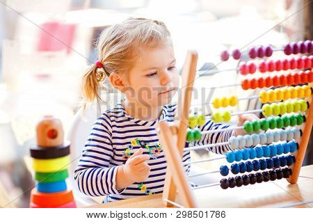 Adorable Cute Beautiful Little Toddler Girl Playing With Educational Wooden Rainbow Toy Pyramid And 