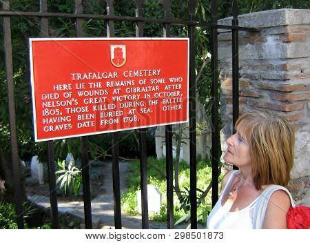 Gibraltar, - Circa 2006. -  Tourist Admires Plack At The Trafalgar Cemetery In Gibraltar.