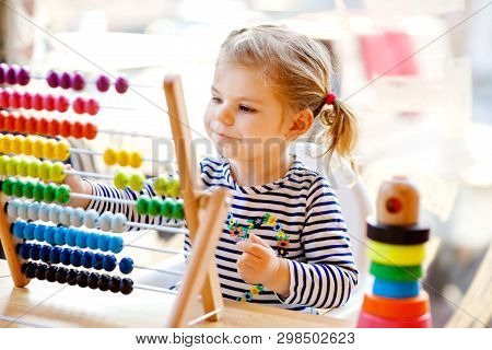 Adorable Cute Beautiful Little Toddler Girl Playing With Educational Wooden Rainbow Toy Pyramid And 