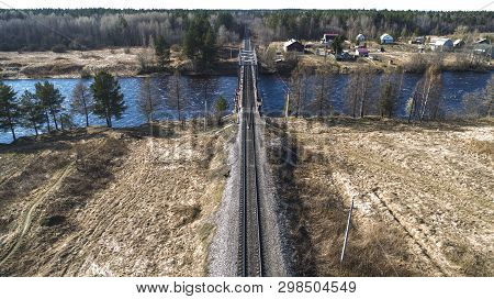 Aerial View On The Rail Bridge Across The River In Rural Place In Spring