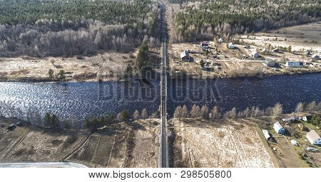 Aerial View On The Rail Bridge Across The River In Rural Place In Spring