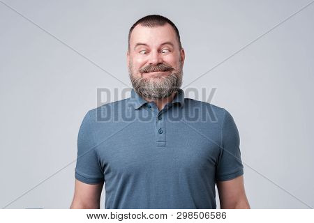 Mature European Man Looking On Nose. Studio Shot