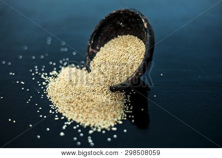 Close Up Of Clay Bowl On Wooden Surface Full Of Poppy Seeds Or Khus Or Opium Poppy Or Breadseed Popp
