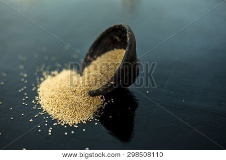 Close Up Of Clay Bowl On Wooden Surface Full Of Poppy Seeds Or Khus Or Opium Poppy Or Breadseed Popp