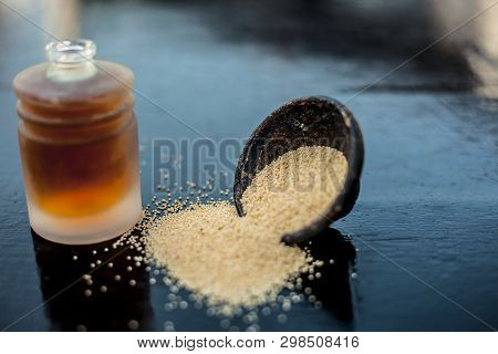 Close Up Of Clay Bowl On Wooden Surface Full Of Poppy Seeds Or Khus Or Opium Poppy Or Breadseed Popp