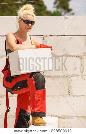 Strong Pretty Woman Working On Construction Site, Building House, Installing Gray Airbricks. Industr