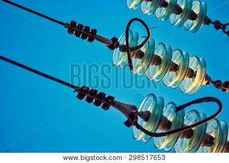 Closeup Of Glass Insulators With High Woltage Wires
