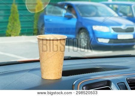 Paper Cup With Tea Or Coffee On Console Car On Sunny Blurred Background. Takeaway. Morning Breakfast