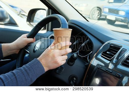 Paper Cup With Tea Or Coffee In Driver Hand In Car On Sunny Blurred Background. Takeaway, Social Med