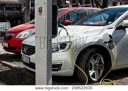 Stockholm, Sweden - April 18, 2019: White Modern Plug-in Volvo V60 Car Plugged And Charging Its Batt