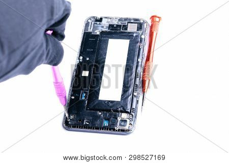 Close-up Photos Showing The Process Of Repairing A Broken Mobile Phone With A Screwdriver In The Lab