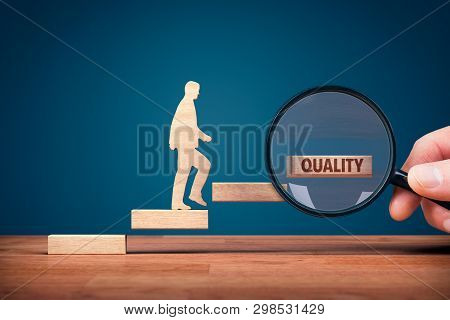 Coach Focused On Motivation To Quality Improvement. Hand With Loupe And Person Made From Wood And Wo
