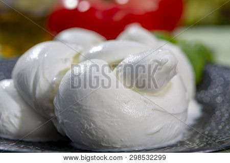 Twisted To Form A Plait Treccia Mozzarella Italian Soft Cheese Served With Fresh Basil And Tomatoes