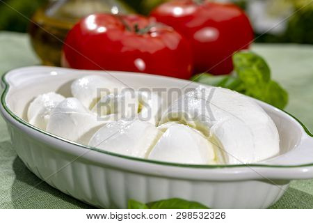 Twisted To Form A Plait Treccia Mozzarella Italian Soft Cheese Served With Fresh Basil And Tomatoes