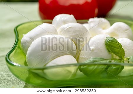 Twisted To Form A Plait Treccia Mozzarella Italian Soft Cheese Served With Fresh Basil And Tomatoes