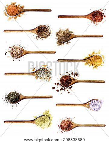 Collection Of Spices In Wooden Spoons: Curry, Coriander,  Dried Paprika, Salt With Chili And Petals,