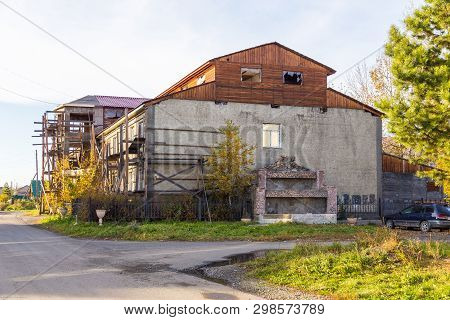 Milkovo, Kamchatka, Russia- 27 September 2014: View Of The Old Residential Building During Renewal A