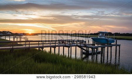 Boat On Dock On An Inlet In North Carolina.