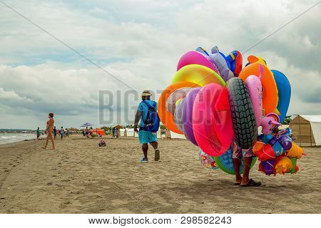 La Boquilla, Cartagena, Colombia - September 18, 2017: A Colorful Floater Salesman Walks On An Almos