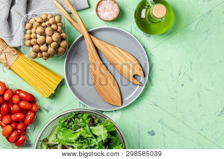 Spaghetti, Shimeji Mushroom, Tomatoes, Olive Oil,  Pink Salt, Empty Ceramic Bowl, Wooden Spoons For 