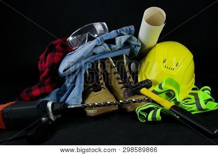 Work Tools For Construction Worker  On Black Background.yellow Crash Helmet, Red Checkered Shirt, Je
