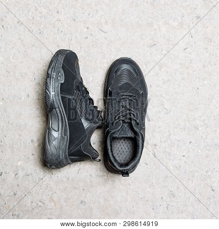 Black Sneakers On A Thick Sole On A Concrete Background