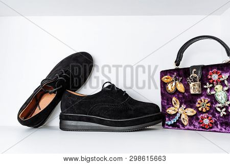 Pair Of Black Boots With Thick Soles And A Purple Velvet Bag Adorned With Animals Made Of Rhinestone