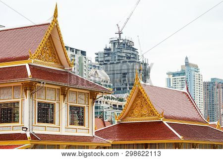 Thai Temple In Front Of Urban Construction. Representative Between Religion And Urban Civilization; 