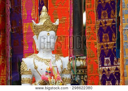 Great White Buddha Statue With Flag Background.