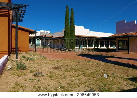May 1, 2019 In Barstow, Ca:  Abandoned Outdoor Shopping Mall Including Closed And Boarded Up Stores 
