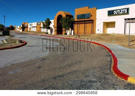 May 1, 2019 In Barstow, Ca:  Abandoned Outdoor Mall With Closed Retail Stores Taken At The Outlet Ma