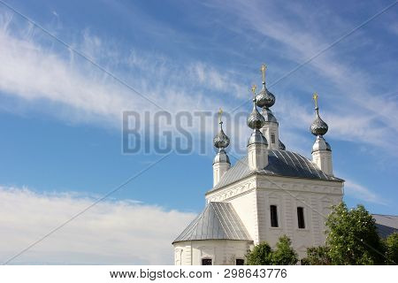 White Church With Five Domes With Golden Crosses And Blue Sky With Clouds On A Sunny Summer Day. Emp
