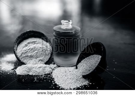 Close Up Of Organic Oil Of Poppy Seeds Or Khus Khus In A Small Glass Bottle With Raw Poppy Seeds And