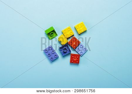Multicolored Details From The Childrens Designer On A Blue Background. Flat Lay, Top View.