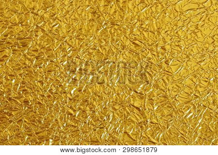 Gold Foil Leaf Shiny Texture, Abstract Yellow Wrapping Paper For Background And Design Art Work.