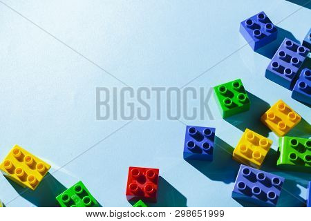 Multicolored Details From The Childrens Designer On A Blue Background. Flat Lay, Top View.