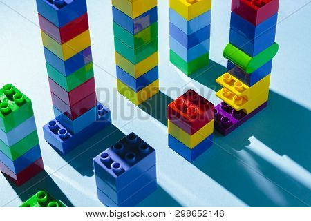 Columns From The Childrens Designer On A Blue Background. The Concept Of Building Houses, New Buildi