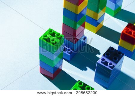 Columns From The Childrens Designer On A Blue Background. The Concept Of Building Houses, New Buildi