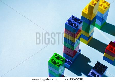 Columns From The Childrens Designer On A Blue Background. The Concept Of Building Houses, New Buildi