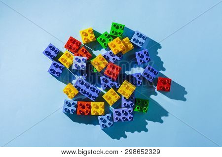 Multicolored Details From The Childrens Designer On A Blue Background. Flat Lay, Top View.