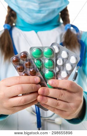 Many Colorful Pills And Tablets In Package, Close Up. Female Nurse In White Robe And Madical Mask, W