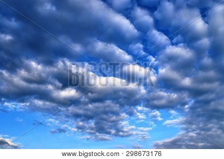 Beautiful Mixed Cloud Formations With White And Grey Cumulus Clouds In The Sunlight On A Blue Sky Se