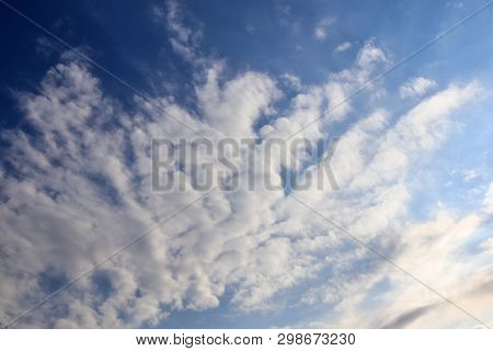 Beautiful Mixed Cloud Formations With White And Grey Cumulus Clouds In The Sunlight On A Blue Sky Se