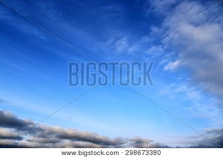 Beautiful Mixed Cloud Formations With White And Grey Cumulus Clouds In The Sunlight On A Blue Sky Se