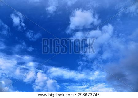 Beautiful Mixed Cloud Formations With White And Grey Cumulus Clouds In The Sunlight On A Blue Sky Se