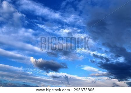 Beautiful Mixed Cloud Formations With White And Grey Cumulus Clouds In The Sunlight On A Blue Sky Se